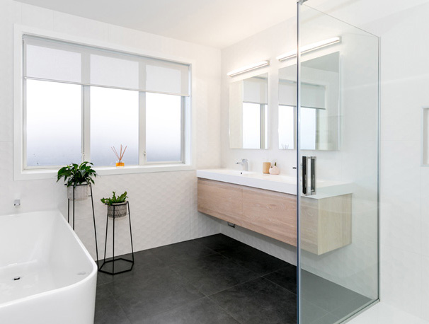 A calm, warmly lit contemporary New Zealand bathroom